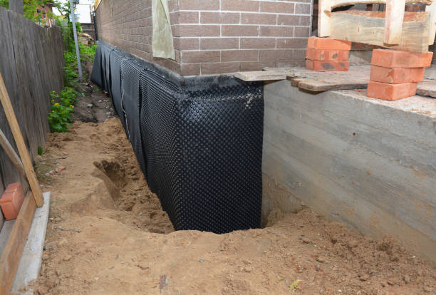 SJ Waterproofing Pros technician performing targeted Exterior Waterproofing assessment in Wales Center, NY